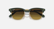 Folding sunglasses top view with dark green frame, gold bridge, brown-tinted lenses