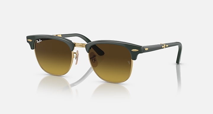 Folding sunglasses with dark green frame and gold accents, brown-tinted square lenses
