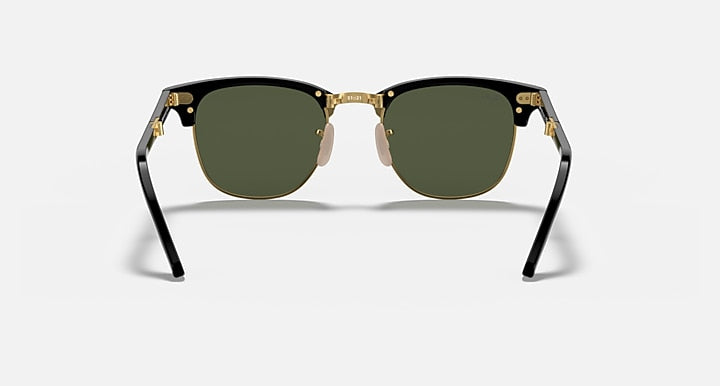 Ray-Ban sunglasses front view with black frame, gold accents, and dark green lenses