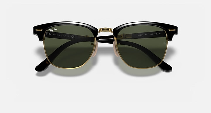 Ray-Ban sunglasses with dark green lenses, black frame, and gold-tone bridge