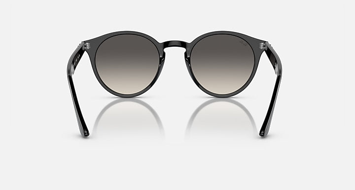 Ray-Ban round sunglasses with black frame and dark tint lenses, angled front