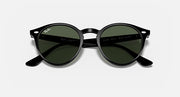 Round sunglasses with black frame and dark green polarized lenses