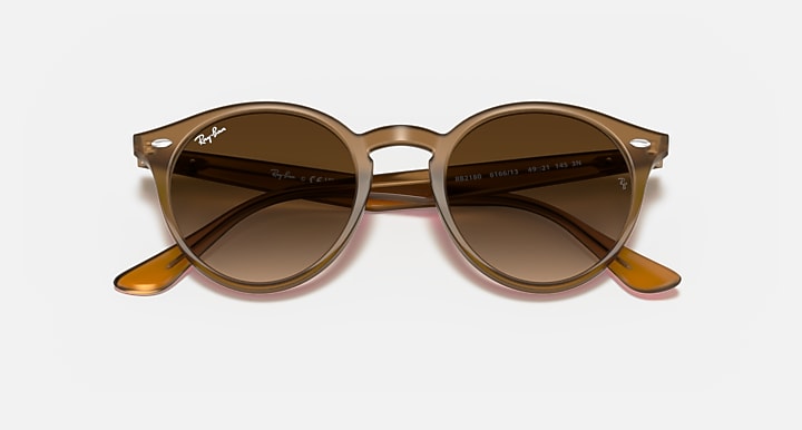 Light brown round sunglasses with brown lenses and orange temple tips