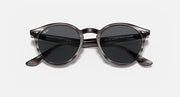Ray-Ban round sunglasses with dark lenses, tortoiseshell frame, and sculpted temple tips