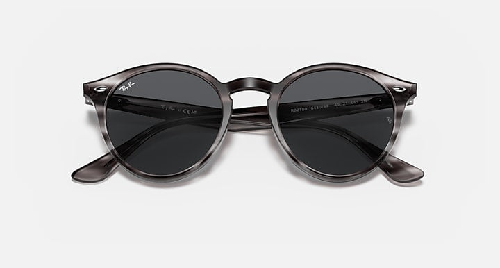 Ray-Ban round sunglasses with dark lenses, tortoiseshell frame, and sculpted temple tips