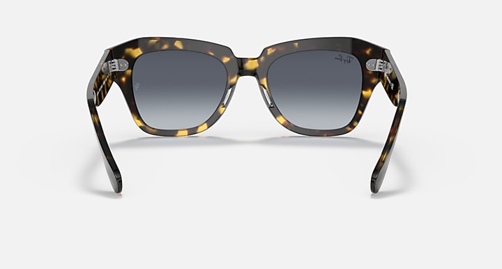 Tortoiseshell square sunglasses with dark grey lenses and thick arms, front view