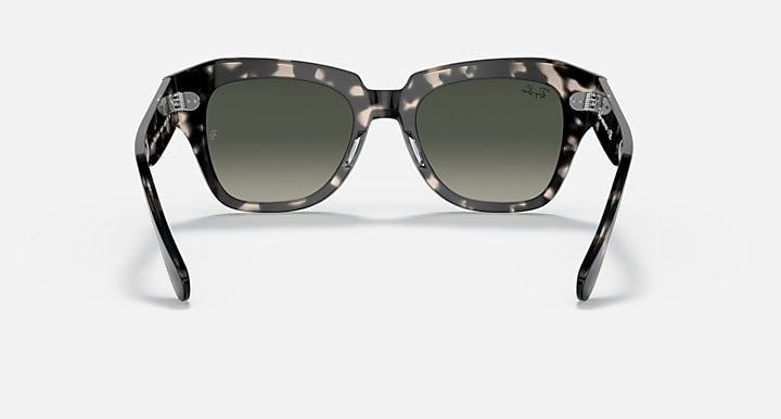 Tortoiseshell square sunglasses with grey-tinted lenses and thick frame, front view