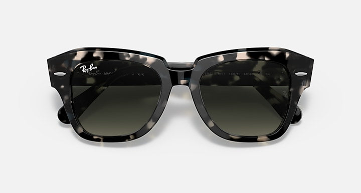 Tortoiseshell square sunglasses with dark green-tinted lenses and thick plastic frame
