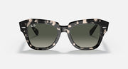 Tortoiseshell square sunglasses with green-tinted lenses and thick frame, front view