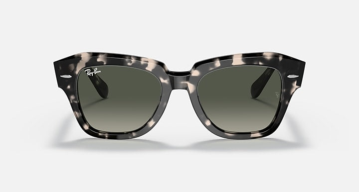 Tortoiseshell square sunglasses with green-tinted lenses and thick frame, front view