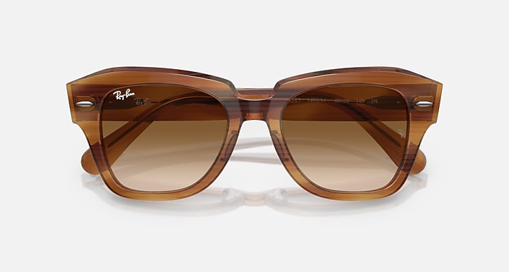 Brown havana sunglasses with dark amber lenses and wide squared frames