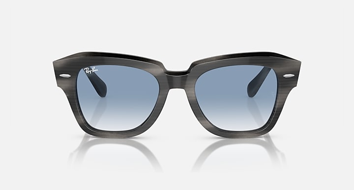 Black sunglasses, front view with light blue lenses and sculpted top edge