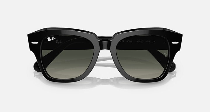 Black square-frame sunglasses with dark green-tinted lenses, front view.