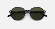 Round black sunglasses with dark green lenses and Ray-Ban logo on temple.
