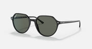 Round black sunglasses with dark green lenses, full rim, and curved arms.