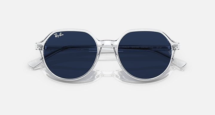 Ray-Ban RB2195 round sunglasses with dark blue lenses and clear frame