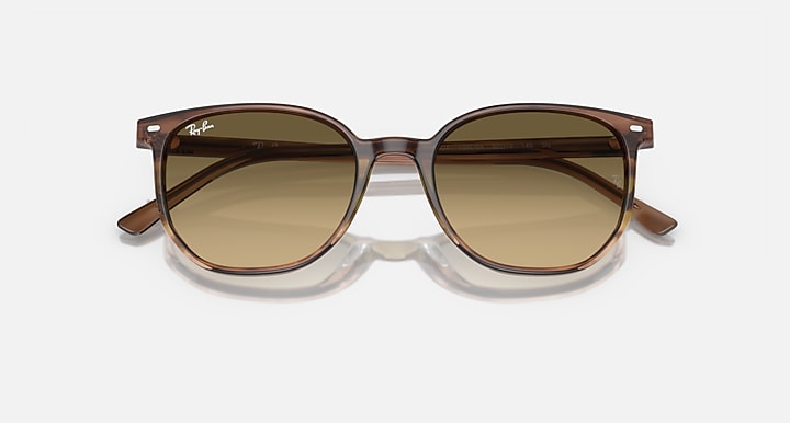 Tortoise-frame sunglasses with olive-brown lenses and rounded silhouette.