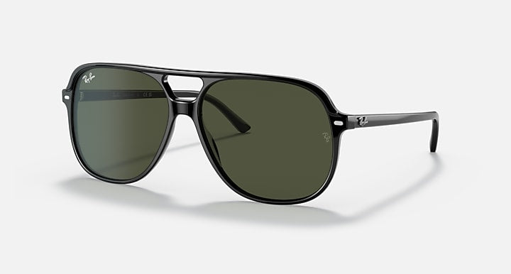 Ray-Ban Bill sunglasses with dark green lenses, black frame, and metal bridge detail.