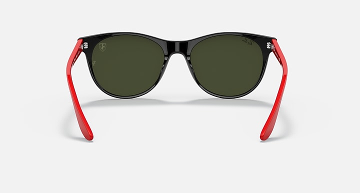 Black cat-eye sunglasses with dark green lenses and red temple arms