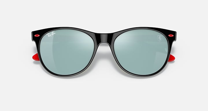 Black cat-eye sunglasses with light green mirrored lenses and red accents on hinges