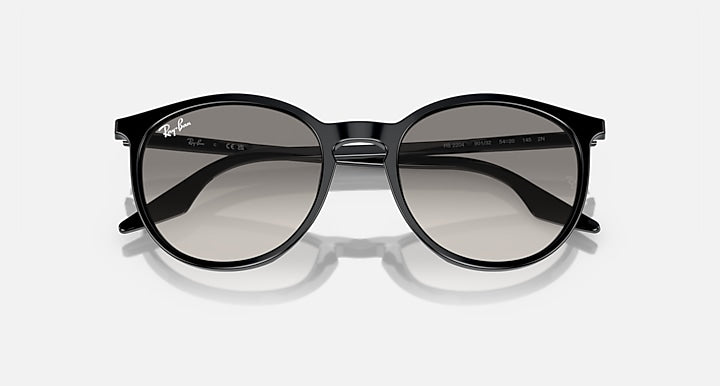 Oversized round sunglasses with dark frame and smoky gray lenses