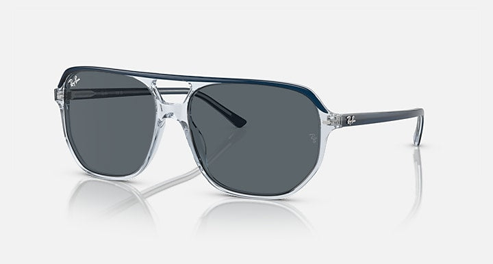 Ray-Ban Bill One RB2205 sunglasses, transparent frame with blue accents and dark gray lenses.