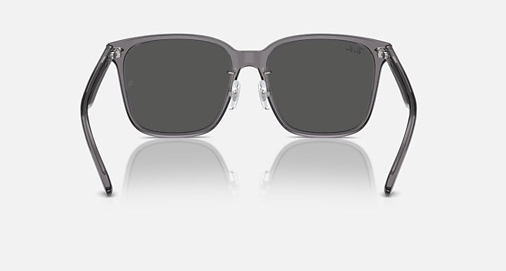 Sunglasses with dark gray lenses and gray-transparent frame, angled front view