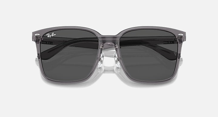 Sunglasses with dark lenses and clear gray frame, front view with thick temples