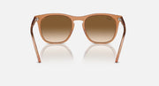 Transparent brown wayfarer-style sunglasses with clear gradient brown lenses and curved frame