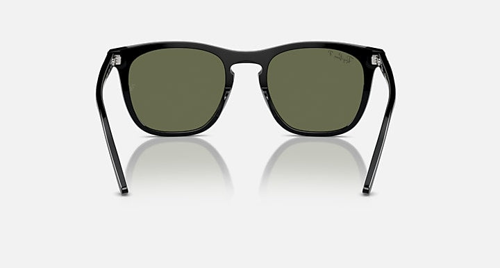 Front view of black sunglasses with dark green lenses and minimal nose gap