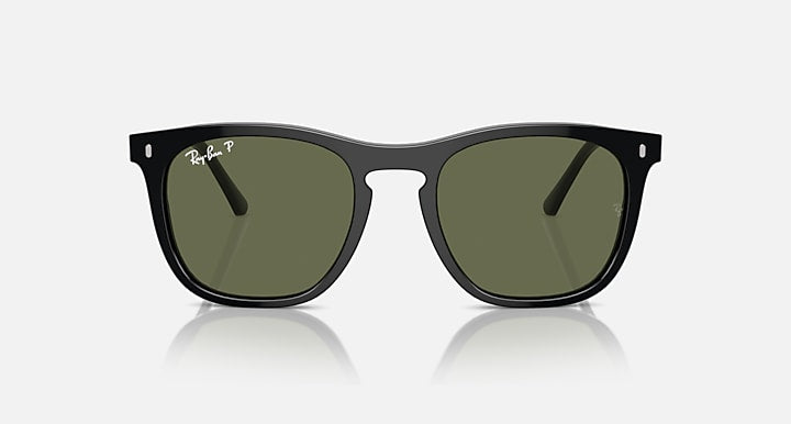 Black sunglasses with dark green lenses and distinctive angular frame silhouette