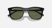 Black sunglasses with dark green lenses, front view with center bridge and temple hinges
