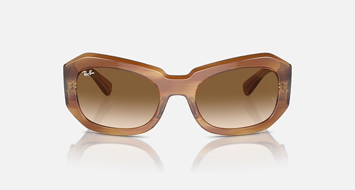 Honey brown sunglasses with tan lenses and thick oval frames, front view
