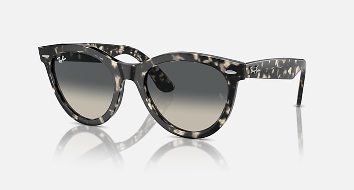 Wayfarer-style sunglasses with dark tortoiseshell frame and gray lenses, side view
