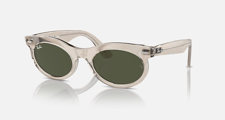 Oval sunglasses with translucent light frame and dark green lenses