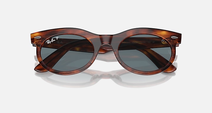 Ray-Ban tortoiseshell oval sunglasses, angled front view with dark lenses
