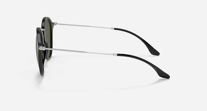 Side-profile sunglasses with metal arms and black temple tips, dark green lenses.