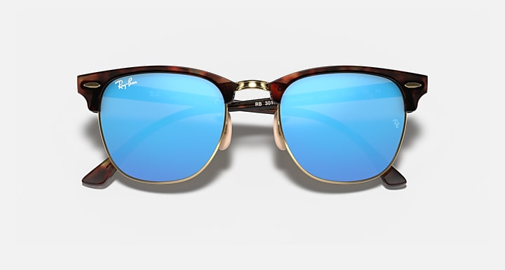 Clubmaster-style sunglasses with tortoiseshell frame and bright blue gradient lenses