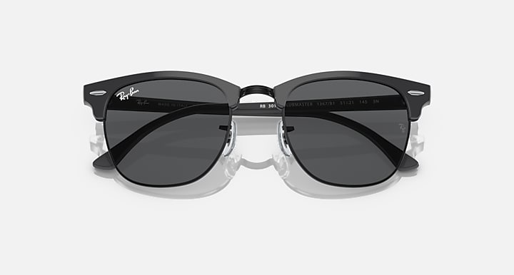 Black Clubmaster-style sunglasses with dark lenses and centered bridge