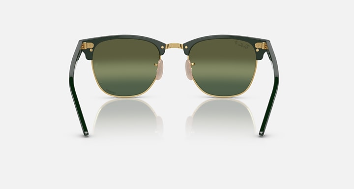 Green Clubmaster-style sunglasses with olive lenses and gold-tone bridge detail