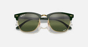 Green Clubmaster-style sunglasses with olive tinted lenses and gold bridge hardware