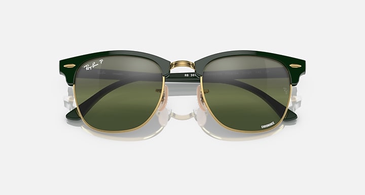 Green Clubmaster-style sunglasses with olive tinted lenses and gold bridge hardware