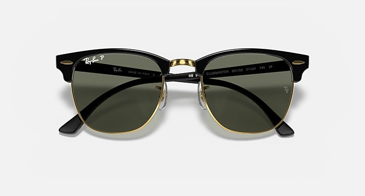 Clubmaster sunglasses with black frame, green lenses, and gold hinge details