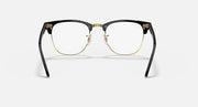Clubmaster-style sunglasses with black frame, clear lenses, and gold-tone eyeglass rims