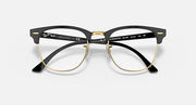 Clubmaster-style sunglasses with black frame and dark gradient lenses, gold-tone accents