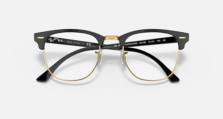 Clubmaster-style sunglasses with black frame and dark gradient lenses, gold-tone accents