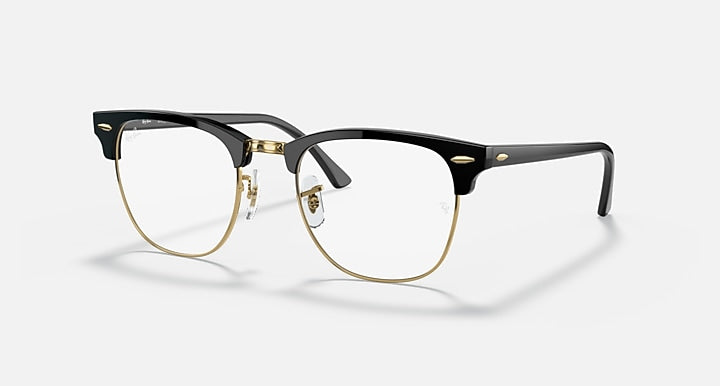 Clubmaster-style sunglasses with black frame, clear lenses, and gold metal temples