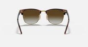 Clubmaster-style sunglasses with tortoiseshell frame and warm brown gradient lenses