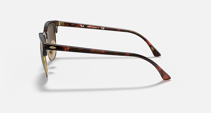 Clubmaster-style sunglasses side profile with tortoiseshell frame and metal temple details