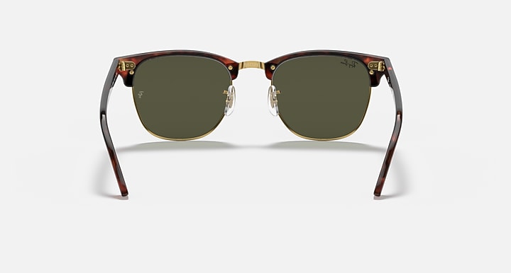 Clubmaster sunglasses with round dark green lenses and tortoise front frame